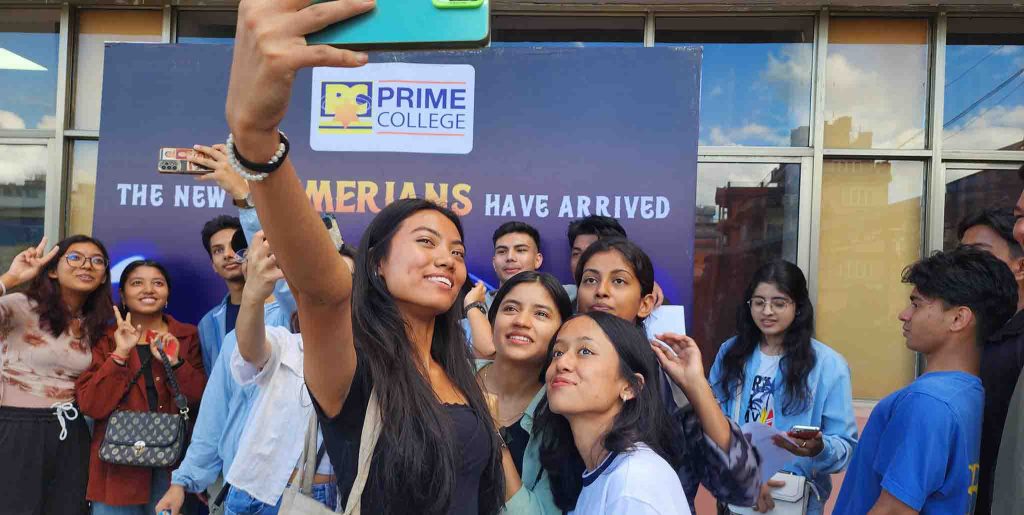 Few Students Posing for a selfie infront of backdrop